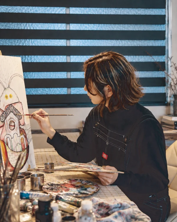 Erika Hirako painting in her studio
